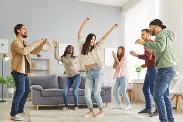 Dancing friends group at home, people enjoy fun, happy dance entertainment, party gathering, students wearing formal wear, event celebration, enjoyment, amusement, enjoyable gathering in living room
