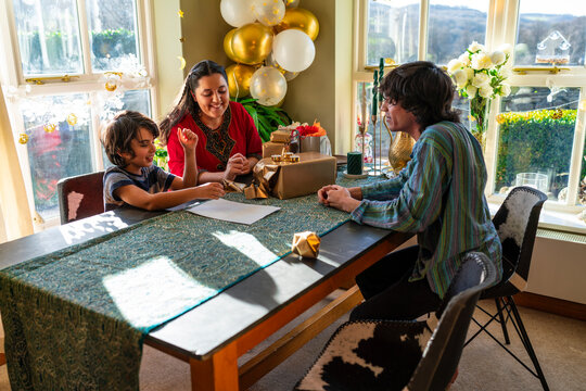 Adult siblings with little sister preparing gifts for Eid Celebration
