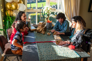Mother with three children preparing gifts for Eid Celebration