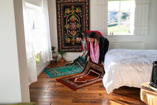 Mother and adult daughter prepare to pray during Eid Celebration
