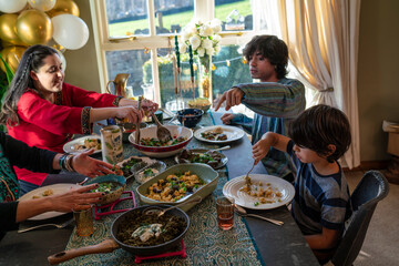 Mother with three children dining during Eid Celebration