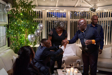 Group of friends celebrating silver wedding anniversary