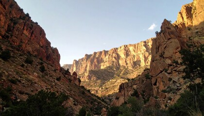 Obraz premium Canyon view with steep rock walls under a sunny sky