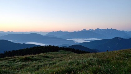 Obraz premium Mountain view at dusk; rolling hills, fog in valley, gradient sky