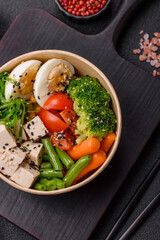 Vegan salad, bowls with chickpeas, broccoli, tomatoes, tofu cheese and boiled eggs