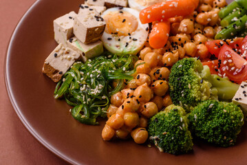 Vegan salad, bowls with chickpeas, broccoli, tomatoes, tofu cheese and boiled eggs