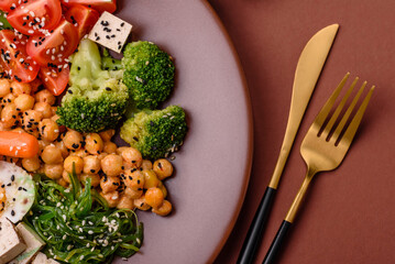 Vegan salad, bowls with chickpeas, broccoli, tomatoes, tofu cheese and boiled eggs