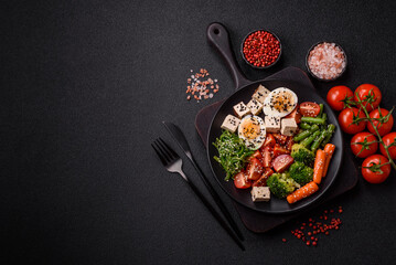 Vegan salad, bowls with chickpeas, broccoli, tomatoes, tofu cheese and boiled eggs