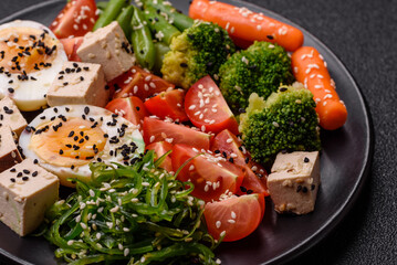 Vegan salad, bowls with chickpeas, broccoli, tomatoes, tofu cheese and boiled eggs