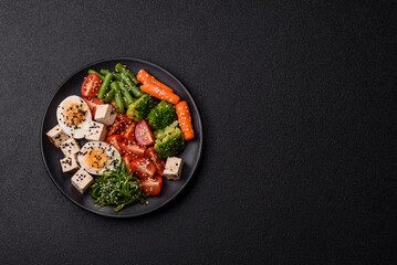 Vegan salad, bowls with chickpeas, broccoli, tomatoes, tofu cheese and boiled eggs
