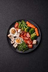 Vegan salad, bowls with chickpeas, broccoli, tomatoes, tofu cheese and boiled eggs