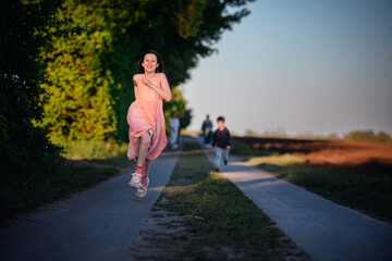 Joyful Girl Running on Country Path at Sunset
