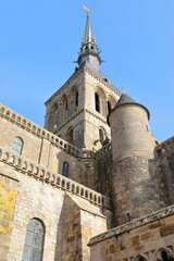 Neo-Gothic spire and St.Michael statue atop Mont-Saint-Michel Church-Abbey Romanesque bell tower, seen from Saut-Gauthier Terrace. Normandy-France-097