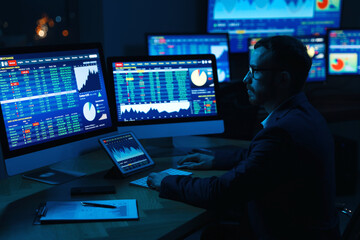 Fototapeta na wymiar Financial trading specialist working in office at night