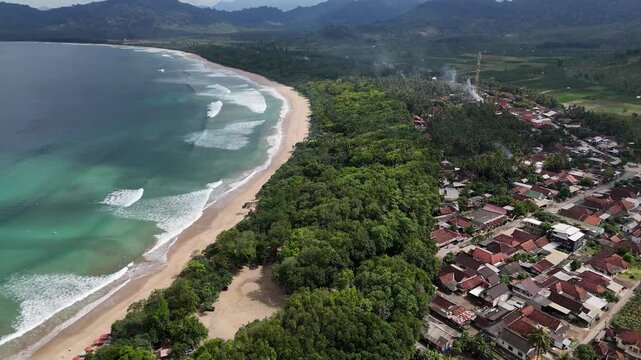 Aerial drone view of red island east java indonesia tropical beach surfers ocean waves