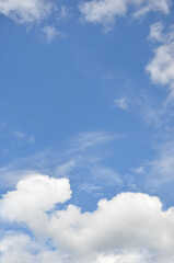 Vertical bright blue sky landscape with white fluffy clouds below . Nature landscape,  environment, beautiful sky background in sunny day.