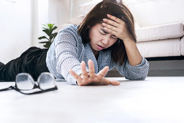 Woman suddenly passes out and falls to the ground, reaching out for help, showing signs of fainting...