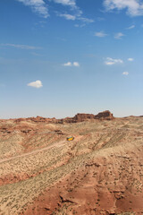 SUV car moving on dusty road at Pingshan Hu Grand Canyon in summer, Zhangye City, Gansu Province in China