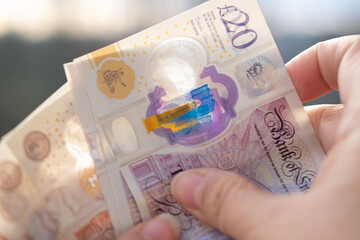 Close-up female hands counting uk pounds bills, paper money on blurred background, British GBP banknotes, Money Management Accuracy, salary, payments to fund, financial freedom, save up for vacation