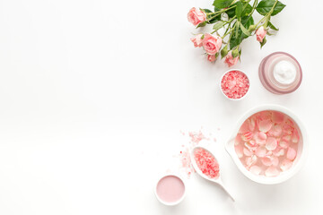 Spa organic cosmetic products with roses essential oil on white background top view
