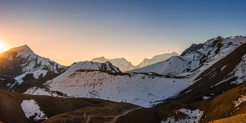 Himalaya mountains at sunrise. Panoramic view of the trekking route to Thorong La pass against Chulu and Annapurna III summits.