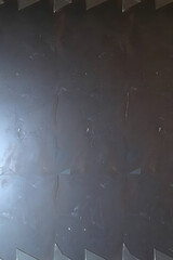 Obraz premium Textured metal surface, industrial mood, dark grey panels with reflective qualities and copy space 