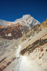A new wide trekking route to Tilicho base camp in sunny autumn day. Annapurna circuit trekking, Himalaya mountains, Nepal.