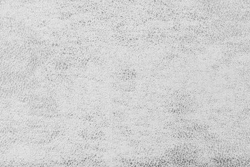 Structure of white suede fabric with abstract shabby texture with embossed shades closeup, macro. Upholstery, decorative cloth structure, canvas for home decor. Background, backdrop, wallpaper.