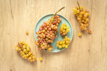 Many fresh green grape clusters isolated, top view