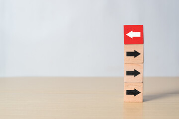 Red block with white arrow going against black arrows. Concept of innovation, courage, and standing...