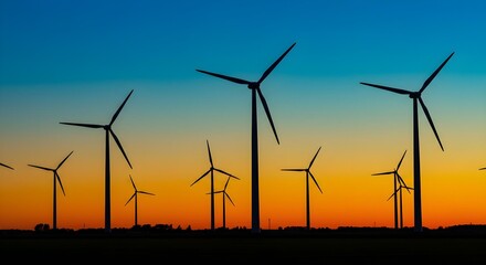 Wind turbines generating clean energy at sunset. The sky is painted with vibrant colors as the turbines harness the power of the wind.