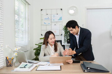 Collaborative Financial Planning. Business partners engaging in financial discussions at a modern office desk.