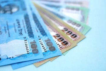 Bangladeshi taka money bills in big amount lies on teal color table close up