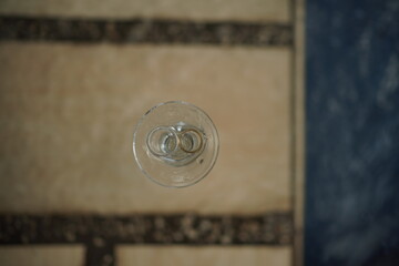 wedding rings on glass