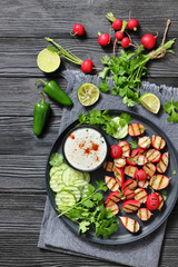 grilled radishes with cucumber slices and sauce
