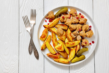meatballs, potatoes, pickles, berries on a plate