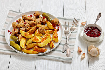 meatballs, potatoes, pickles, berries on a plate
