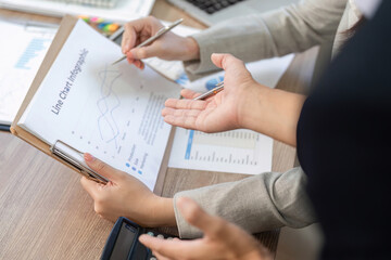 Financial Consultation and Collaboration. Business professionals discussing financial data in an office setting.