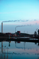 Factory on a river during evening