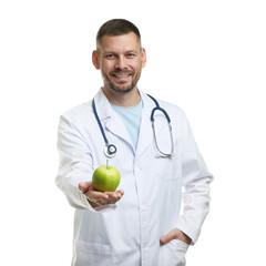 Nutritionist with green apple and stethoscope on white background
