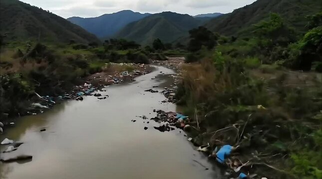 Degradation Evident: Polluted Stream Meandering Through Mountains