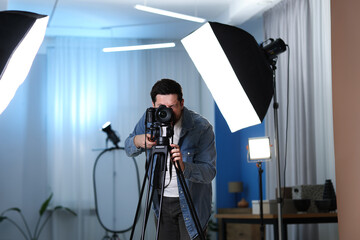 Man with professional video camera in studio