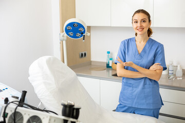 Portrait of young caucasian woman cosmetologist standing in her office.