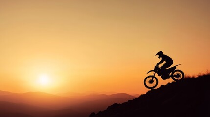 Fototapeta premium Off-road rider descending rocky hill during evening twilight