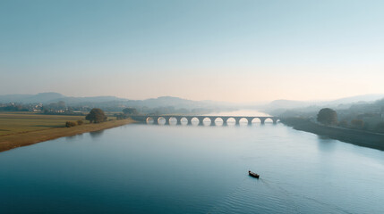 breathtaking aerial view of ancient bridge spanning serene river with solitary fishing boat gently floating in