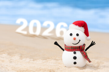 A Snowman on a beautiful beach with large 2026 numbers set in the background