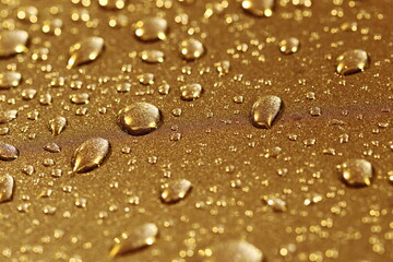 Background with gold drops and golden bokeh