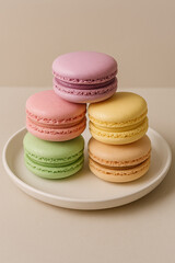 Obraz premium Pastel macarons stacked on a white plate