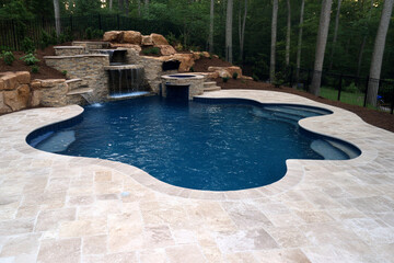 Swimming pool installation chaos in a backyard surrounded by nature