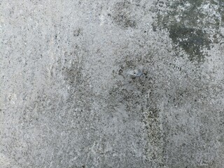Weathered Concrete Surface with Dark Stains. Close-up of old concrete wall with dark moldy stains...